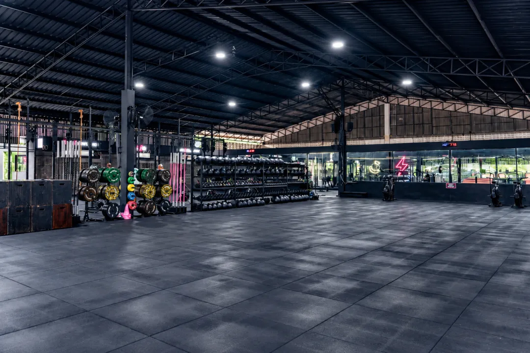 Open training floor with weight racks and lifting equipment at CULT Rawai.