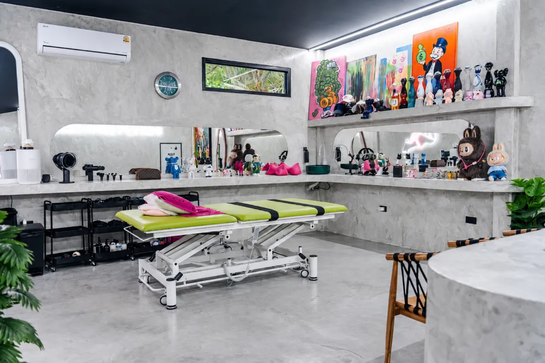 Treatment room with a therapy table and exercise equipment at CULT BodyShop.